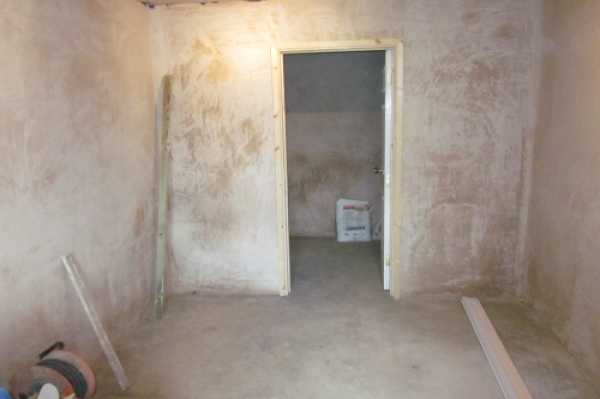 This shows the plastered finish to the utility and playroom with door to small lockup.